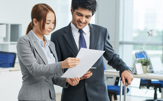 Screenshot 2026-09-20 at 11-09-09 Man and woman in business suits standing in office with suitcases and looking together at document Free Photo